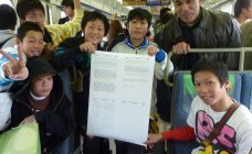 School-boys-on-Osaka-train-with-rail-message